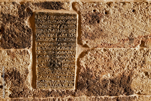 A stone tablet carved in Aramaic script lists the names of the patriarchs entombed at Deyrulzafaran Monastery in Mardin, Eastern Anatolia, Turkey photo