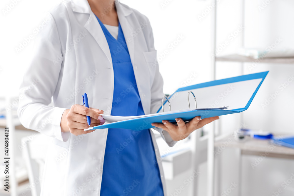 Female doctor with folder in medical office Female doctor with folder in medical office