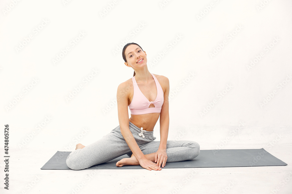 A beautiful girl is engaged in a yoga studio A beautiful girl is engaged in a yoga studio