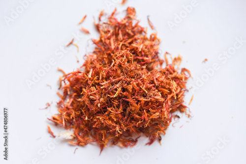 Dried safflower for herbal tea on white background, dry safflower petals, Saffron substitute