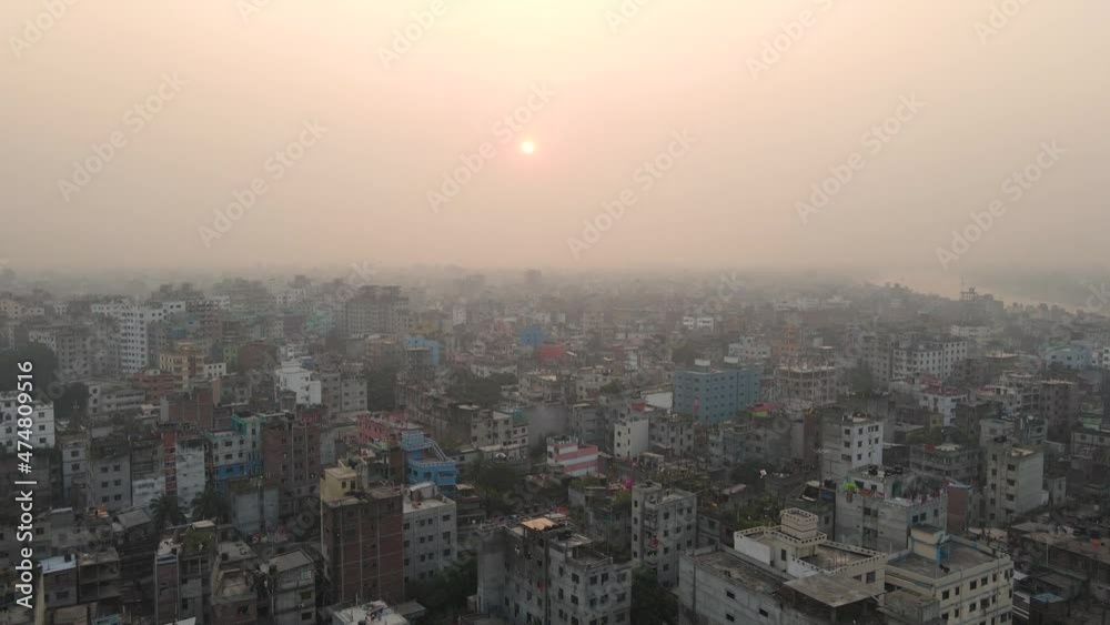 Sunrise over the dramatic cityscape of Dhaka in Bangladesh, aerial drone flight shot Sunrise over the dramatic cityscape of Dhaka in Bangladesh, aerial drone flight shot