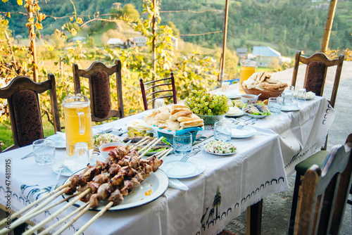 Georgian feast on the vineyard at sunset photo