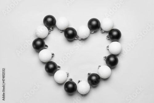 Heart made of beautiful Christmas balls on white background
