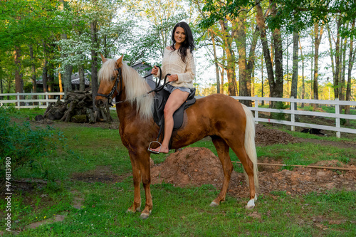 A Lovely Brunette Model Poses With Her Horse Outdoors While Enjoying The Spring Weather