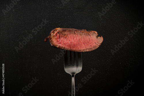 Fork and well-cooked steak.