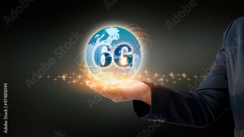 Close-up shot of mobile holding 6G hologram. Futuristic technology concept and internet speed.