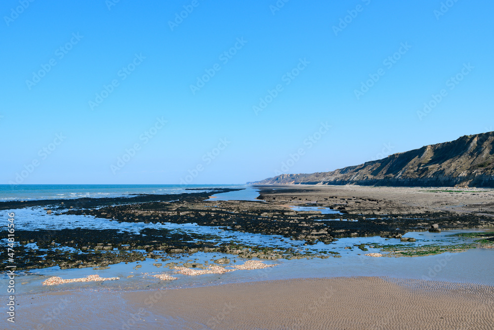 The fine sand beach of the city of Port en Bessin in Europe, France, Normandy, towards Omaha beach, in spring, on a sunny day.