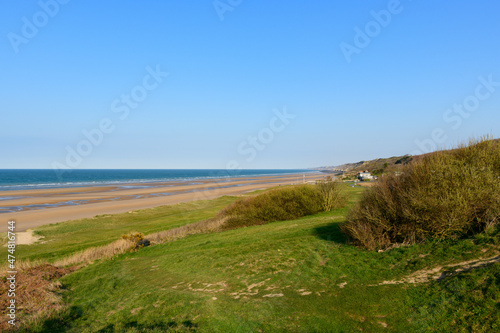 The end of Omaha beach in Europe, France, Normandy, towards Arromanches, Colleville, in spring, on a sunny day.