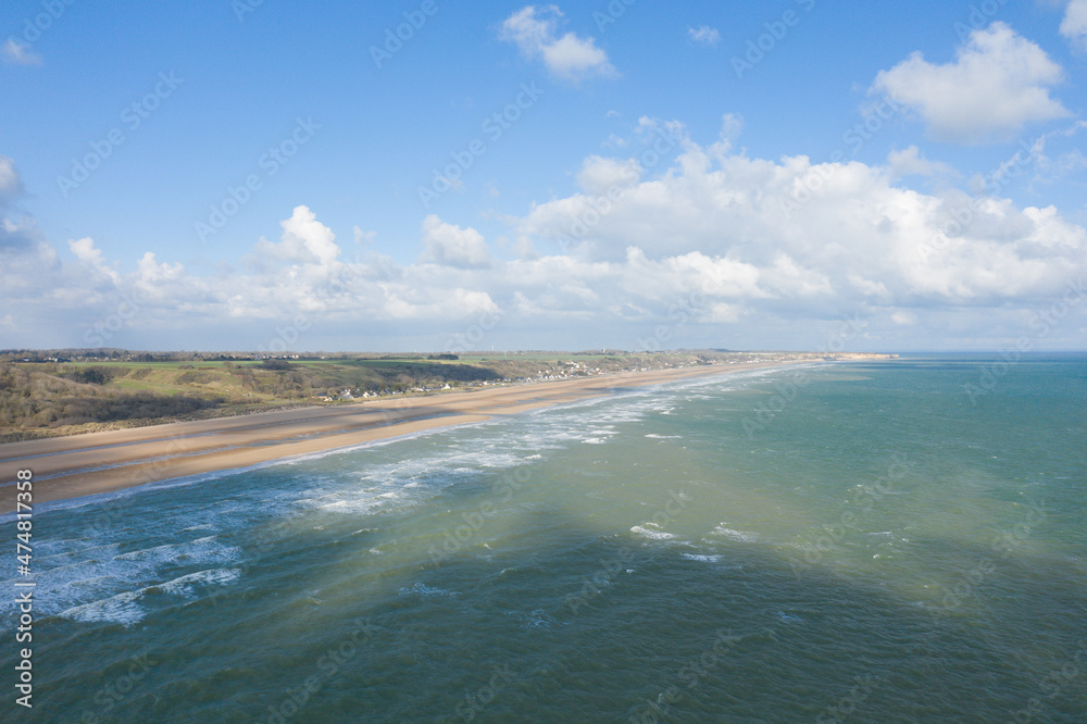 The fine sand beach of Omaha beach in Europe, in France, in Normandy, towards Arromanches, in Colleville, in spring, on a sunny day.
