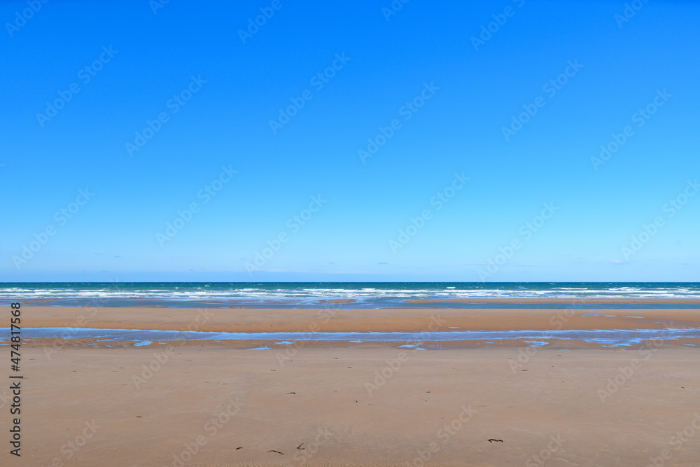 The famous fine sandy beach of Omaha beach in Europe, France, Normandy, towards Arromanches, Colleville, in spring, on a sunny day.