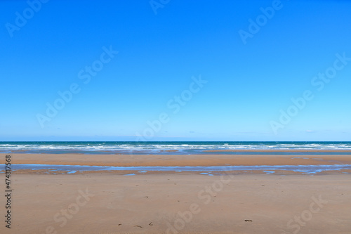 The famous fine sandy beach of Omaha beach in Europe, France, Normandy, towards Arromanches, Colleville, in spring, on a sunny day.