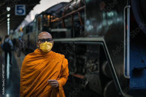 Monk walks into Bangkok Railway Station in Thai call Hua Lamphong with an ancient Pacific type steam locomotives from Japan No.824 in special nostalgic trips.