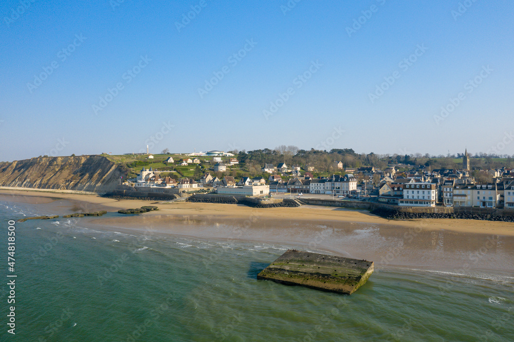 Obraz premium The town of Arromanches les Bains and the American artificial port in Europe, France, Normandy, Arromanches les Bains, in summer, on a sunny day.