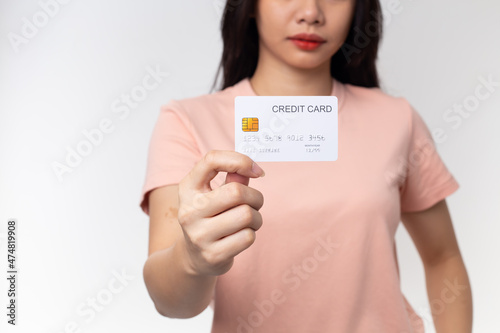 Close up Young Asian woman holding credit card isolated on a white background