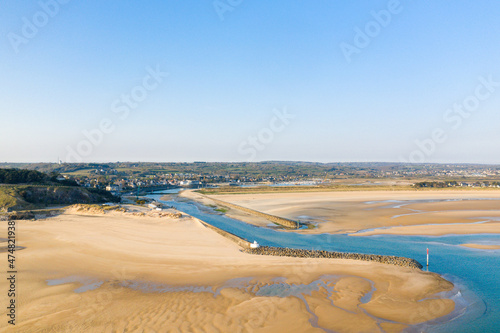 The Plage de la Potiniere and the sea wall of the port of Barneville Carteret in Europe, France, Normandy, Manche, in spring, on a sunny day. photo
