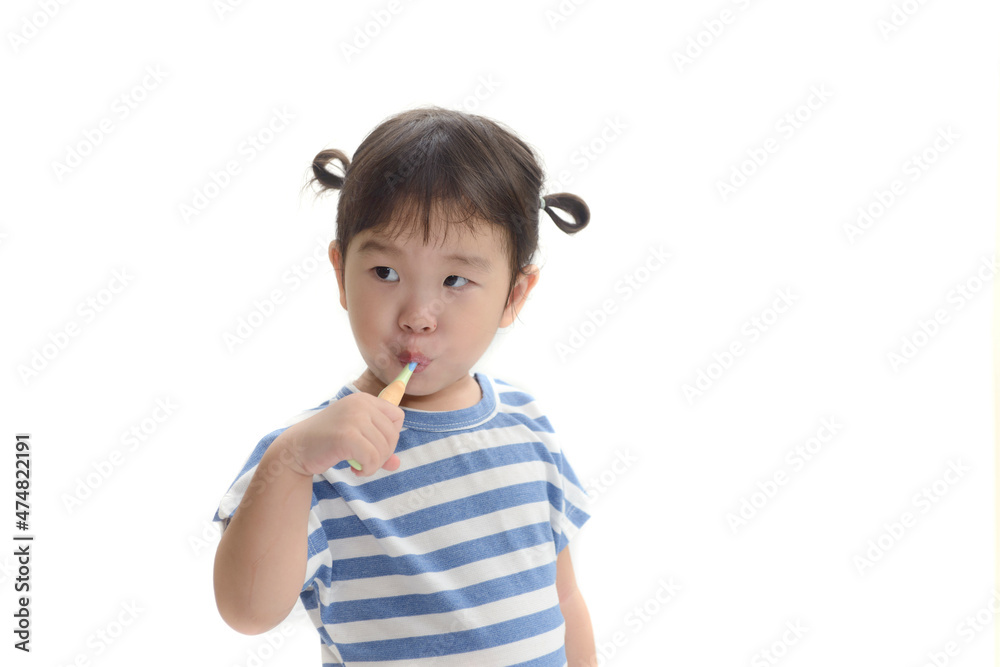 Little asian girl brushing her teeth on white background Little asian girl brushing her teeth on white background