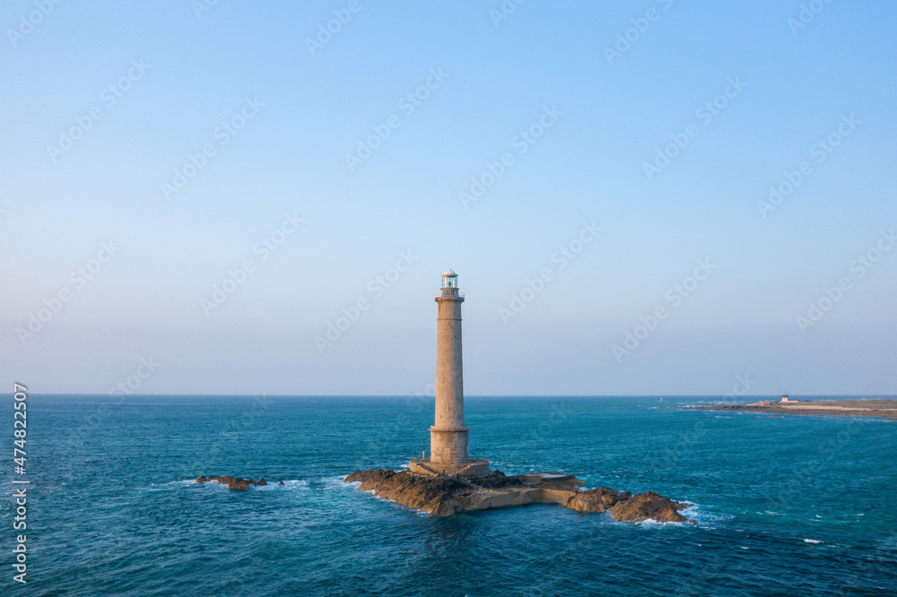 The lighthouse of Cap de la Hague on its steep rock in Europe, France, Normandy, Manche, in spring, on a sunny day.