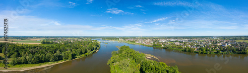 The panoramic view of the city of Sully sur Loire and its river in Europe, in France, in the Center region, in the Loiret, in summer, on a sunny day.