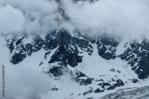 The Aiguille du Midi and the Bossons glacier supplied by a helicopter in the Mont Blanc massif in Europe, France, the Alps, towards Chamonix, in summer.