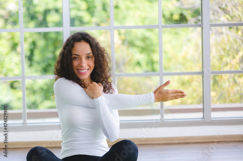 young African American woman learning to exercise workout with Yoga by watching laptop at home