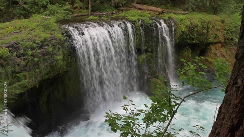 Waterfall and natural reservoir at wild forest. Wonderful fresh water waterfalls river flowing. Forest rocks with a roaring stream running. Panoramic landscape of waterfall. Spirit of adventure