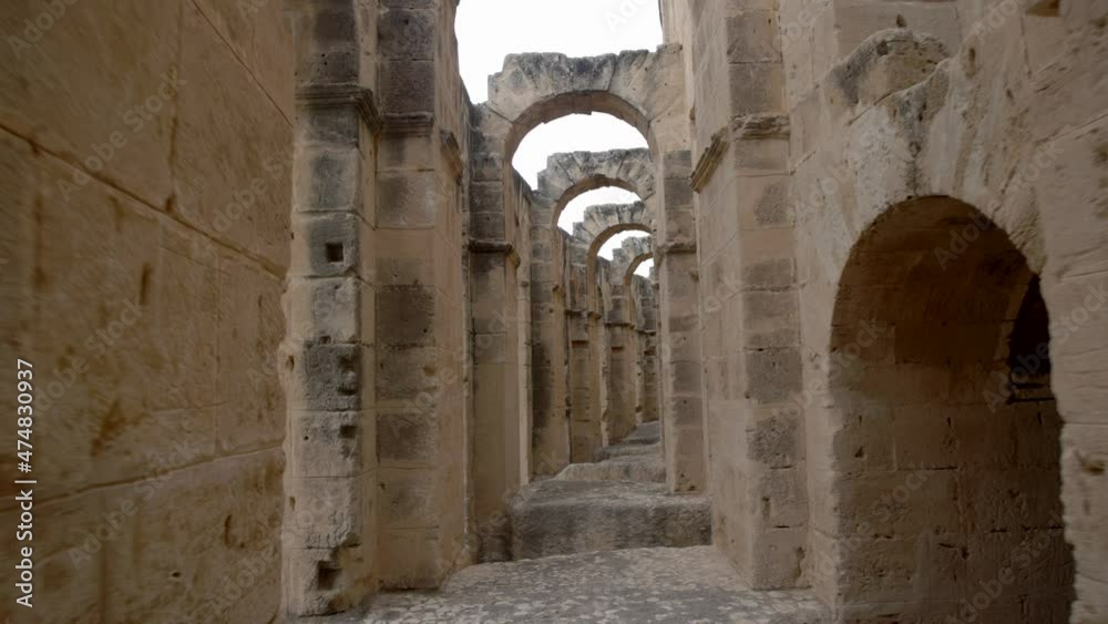 Arch Corridor Of Ancient Roman Ruins In El Jem Amphitheater In Tunisia. Pullback Arch Corridor Of Ancient Roman Ruins In El Jem Amphitheater In Tunisia. Pullback
