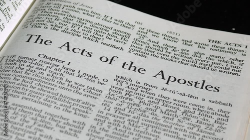 Close Up of Bible Page Turning to the book of Acts