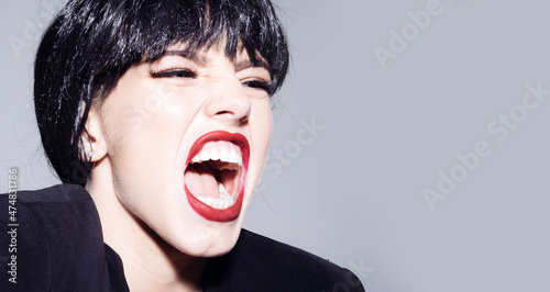 Excited angry woman screaming and shouting. Human emotions, facial expression concept. Shout and scream mouth.