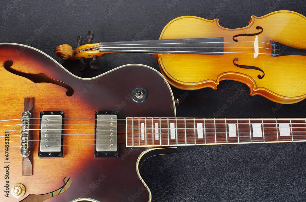 Fototapeta premium Jazz electric guitar and violin on a black background.