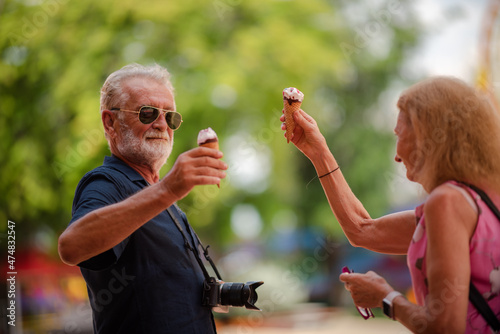 elderly senior couple woman and man having fun and happy together at amusement them park