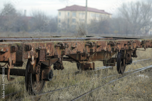 Shallow depth of field (selective focus) image with old and rusty railway industrial transportation waggon (dresine). photo