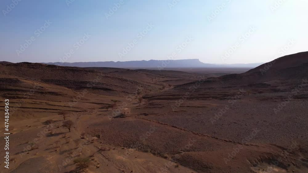 Cinematic aerial flight over Moroccan Sahara Desert with sand dunes and dried fields during sunny day in Morocco,Africa Cinematic aerial flight over Moroccan Sahara Desert with sand dunes and dried fields during sunny day in Morocco,Africa