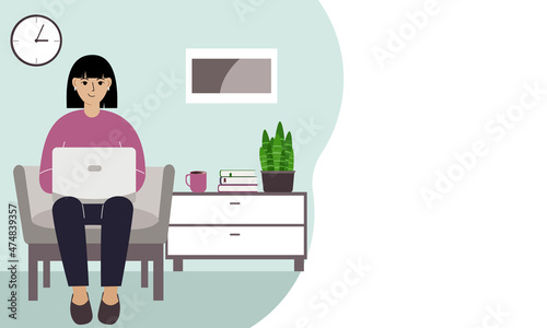 A woman sits with a laptop on an armchair at home. I work on a computer. Freelance, online education or social media concept.