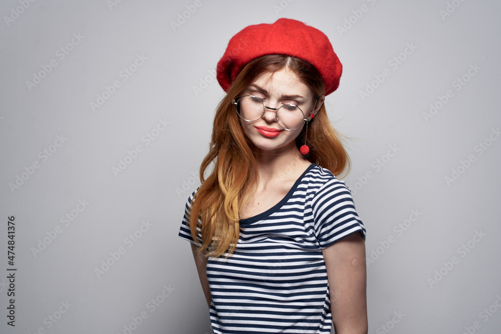 Frenchwoman in a striped t-shirt red lips gesture with his hands summer Frenchwoman in a striped t-shirt red lips gesture with his hands summer