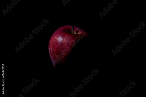 red apple on black background