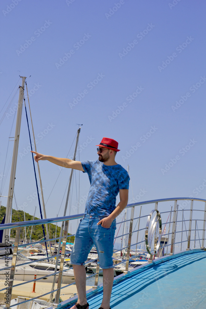 handsome man in a red hat  looking to the sea