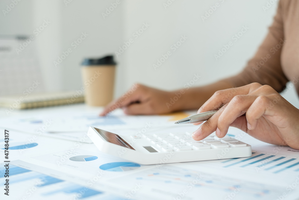 work from home, The hand of a woman who works in finance sits at his desk at home and calculates financial graphs showing the results of his investments, planning the steps of his business growth work from home, The hand of a woman who works in finance sits at his desk at home and calculates financial graphs showing the results of his investments, planning the steps of his business growth