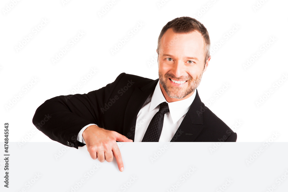 Smiling businessman pointing at blank sign Smiling businessman pointing at blank sign