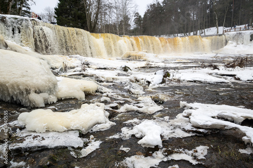 Partly frozen Keila-Joa waterfall in winter photo