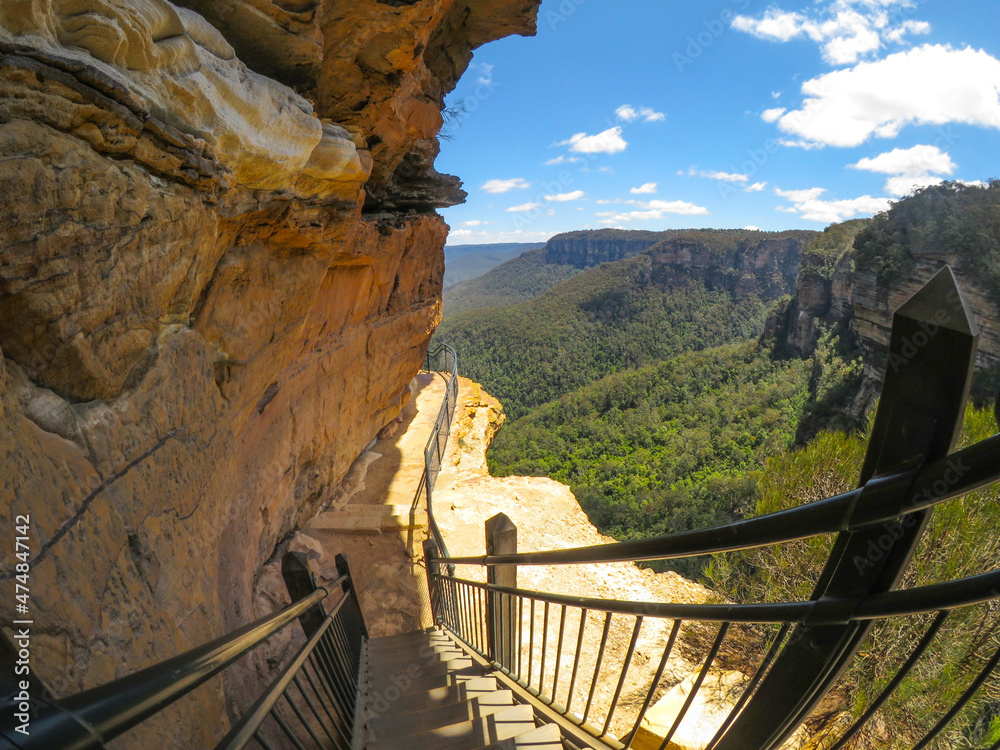Fototapeta premium Hiking trail along the cliff with beautiful mountain view of Wentworth Falls, New South Wales, Australia.