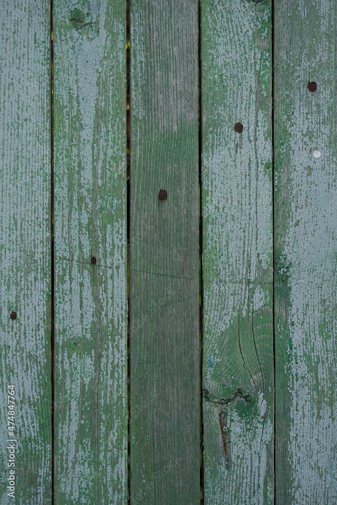 texture of a wooden fence. fence painted green. peeling paint on an old fence. old wood texture. photo can be used as a photophone, as a texture texture of a wooden fence. fence painted green. peeling paint on an old fence. old wood texture. photo can be used as a photophone, as a texture