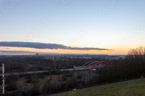 View from the Müllberg over the city of Augsburg towards the Alps in the evening at sunset