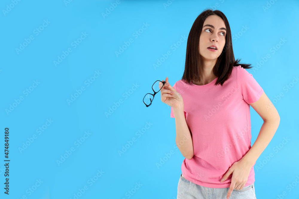 Attractive girl with glasses on blue background Attractive girl with glasses on blue background