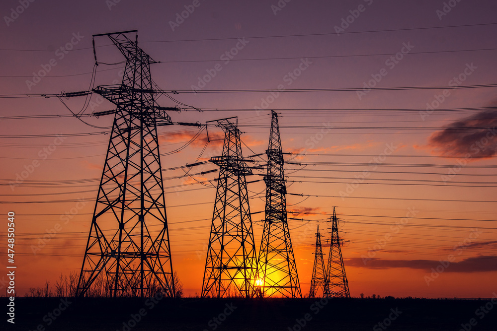  high-voltage  power lines at sunset.