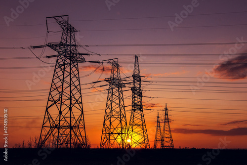  high-voltage  power lines at sunset. © Lumppini