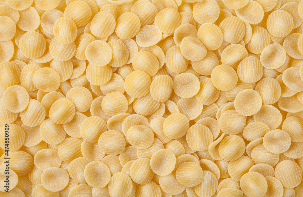 Uncooked orecchiette pasta background