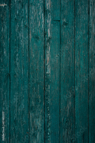 texture of a wooden fence. fence painted green. peeling paint on an old fence. old wood texture. photo can be used as a photophone, as a texture