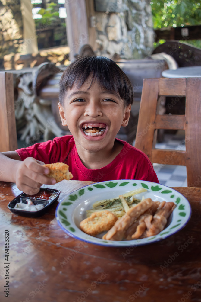 a boy is having breakfast snacks a boy is having breakfast snacks