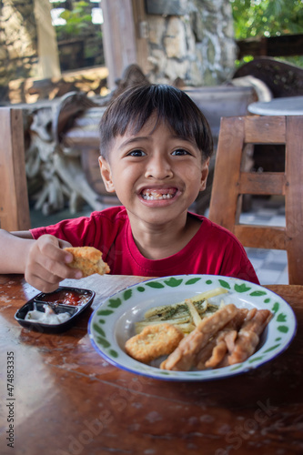 a boy is having breakfast snacks