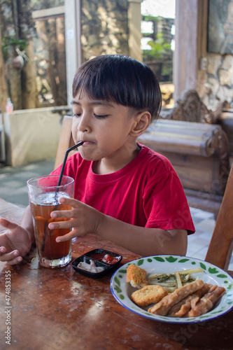 a boy is having breakfast snacks